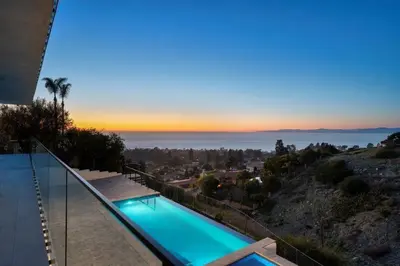 a swimming pool with a view of the ocean at Ocean Vista in Palos Verdes Estates