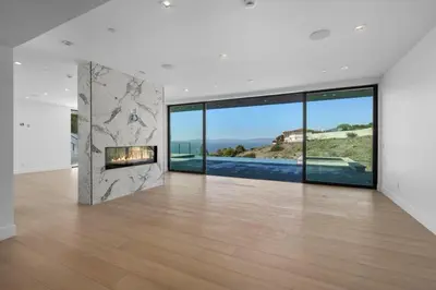 a living room with a fireplace in a house at Ocean Vista in Palos Verdes Estates