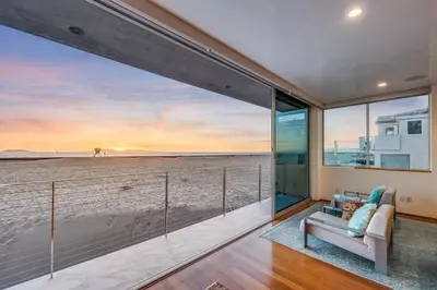 a living room with a view of the beach at Modern Ocean Front Beach Home- 3 king beds 3 bedroom in Oxnard