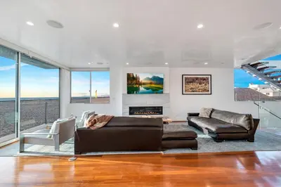 a living room with a couch and a fireplace at Modern Ocean Front Beach Home- 3 king beds 3 bedroom in Oxnard