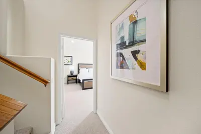 a hallway leading to a bedroom with a picture on the wall at Modern townhouse - 4 Bedroom 3Bathroom near Pasadena, LA in Duarte