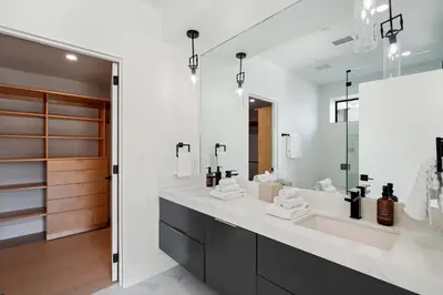 a bathroom with a large sink and a large mirror at Samara by Stay Awhile Villas in Malibu