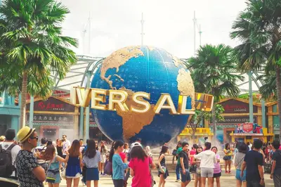 a large globe in the middle of a crowd of people at Claudia's Guest House in Los Angeles