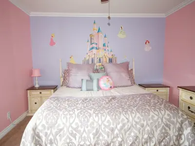 a bedroom with a large bed with a castle on the wall at F-28 The Wonderland House in Anaheim