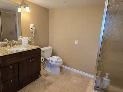a bathroom with a toilet and a sink and a shower at F-28 The Wonderland House in Anaheim