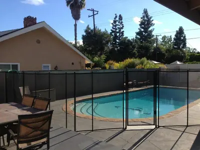 a fence around a swimming pool in a yard at F-28 The Wonderland House in Anaheim