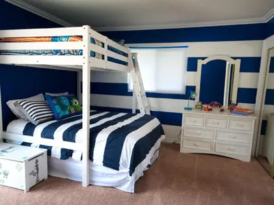 a bedroom with a bunk bed and a mirror at F-28 The Wonderland House in Anaheim