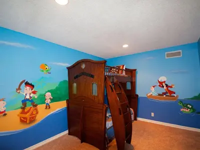 a childs bedroom with a cartoon themed wall at F-29 The Pirates Cove in Anaheim