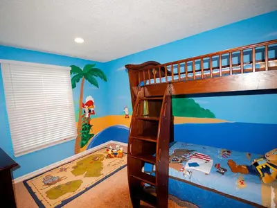 a childs bedroom with a bunk bed with blue walls at F-29 The Pirates Cove in Anaheim