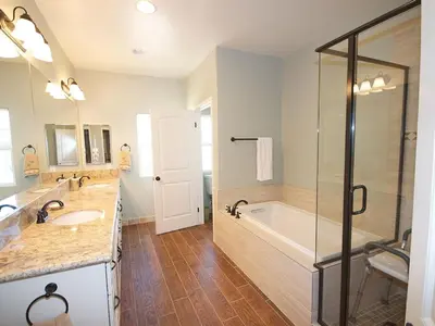 a bathroom with a tub and a sink and a shower at F-31 Mickeys Beach House in Anaheim