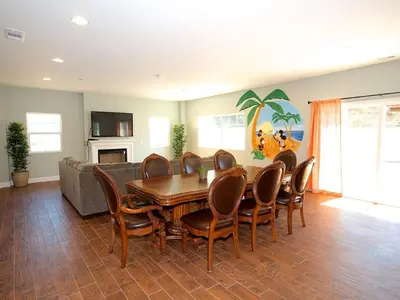 a living room with a wooden table and chairs at F-31 Mickeys Beach House in Anaheim