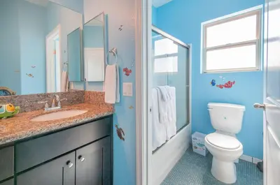a blue bathroom with a toilet and a sink at F-32 La Casa de Mickey in Anaheim