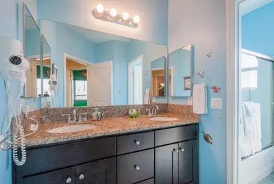 a bathroom with two sinks and a large mirror at F-32 La Casa de Mickey in Anaheim