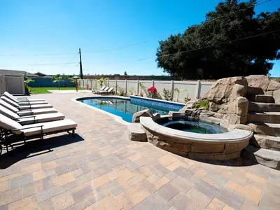 a patio with a pool and a bench next to at F-32 La Casa de Mickey in Anaheim