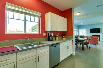 a kitchen with a sink and a red wall at F-33 Walts Place in Anaheim