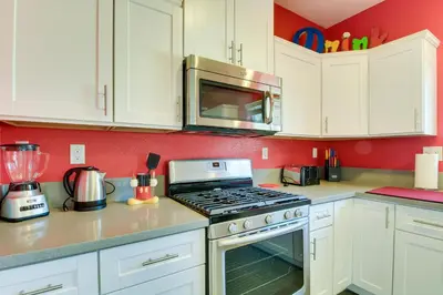 a kitchen with white cabinets and a stove top oven at F-33 Walts Place in Anaheim