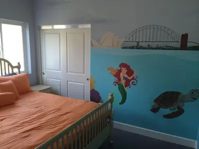 a bedroom with a mermaid mural on the wall at F-33 Walts Place in Anaheim