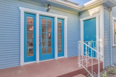 a home with blue doors and a balcony at F-39 Helena in Anaheim