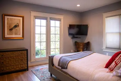 a bedroom with a bed and a flat screen tv at F-39 Helena in Anaheim