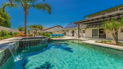a swimming pool in front of a house at F-51 Orangewood in Anaheim