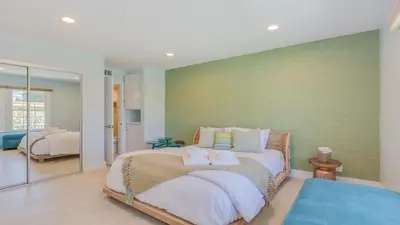 a bedroom with a bed with two towels on it at F-51 Orangewood in Anaheim