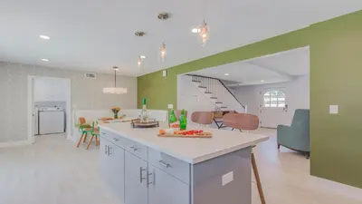 a kitchen and living room with green and white at F-51 Orangewood in Anaheim