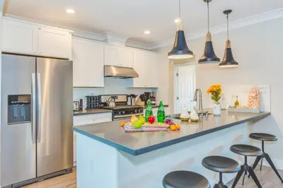 a kitchen with white cabinets and stainless steel appliances at F-52 Trenton II in Anaheim