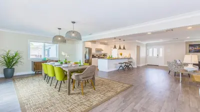 a dining room and living room with a table and chairs at F-52 Trenton II in Anaheim