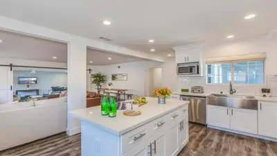 a kitchen with white cabinets and a counter top at F-53 Trenton in Anaheim
