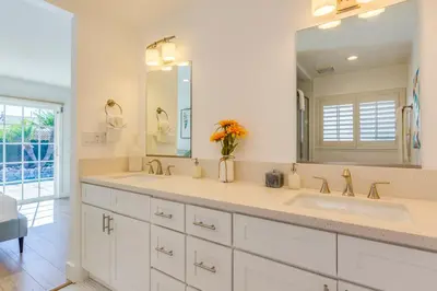 a bathroom with two sinks and a large mirror at F-54 Maverick in Anaheim