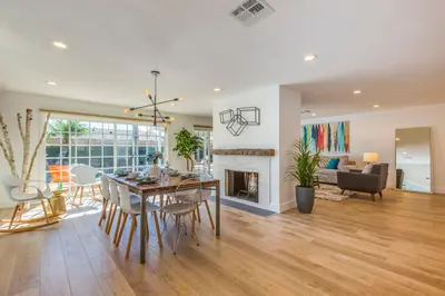 a living room with a dining table and a fireplace at F-54 Maverick in Anaheim