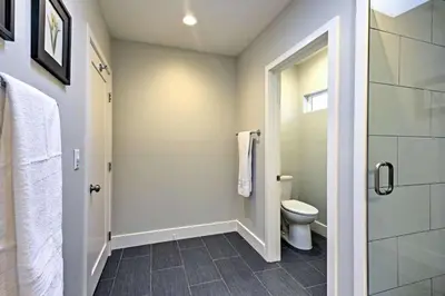 a bathroom with a toilet and a walk in shower at F-55 Donald Ducks Cottage in Anaheim