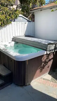 a hot tub sitting on the side of a fence at F-55 Donald Ducks Cottage in Anaheim