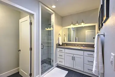 a bathroom with a shower and a sink and a mirror at F-55 Donald Ducks Cottage in Anaheim