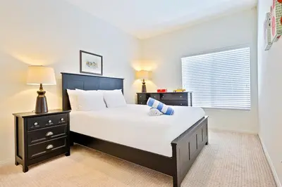 a bedroom with a large white bed and a window at F-56 Winnie the Poohs Treehouse in Anaheim