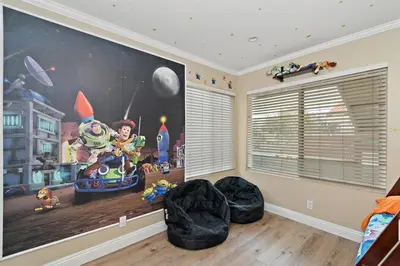 a room with a large painting on the wall at F-57 Pride Rock in Anaheim