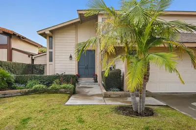 a palm tree in front of a house at F-57 Pride Rock in Anaheim
