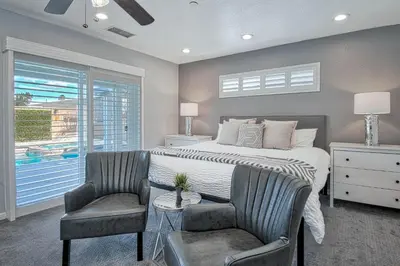 a bedroom with a bed and two chairs and a window at F-58 Mandos Hideaway in Anaheim