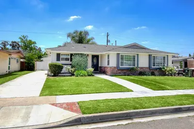 a house with a driveway and grass at F-59 Goodhue in Anaheim