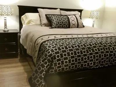 a bed with a black and white comforter and pillows at F-60 Disney Dream Craftsman in Anaheim