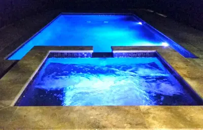 a large swimming pool with blue lights in it at F-60 Disney Dream Craftsman in Anaheim