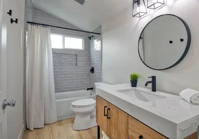 a bathroom with a sink and a toilet and a mirror at F-64 California Vibes in Anaheim