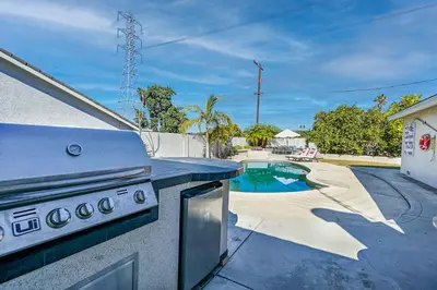 a kitchen with a stove and a swimming pool at F-65 Adventure House in Anaheim