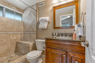 a bathroom with a toilet and a sink and a shower at F-66 Poolside Retreat in Anaheim