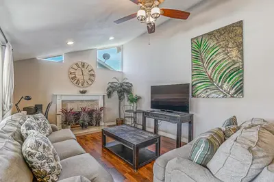 a living room with a couch and a table at F-66 Poolside Retreat in Anaheim