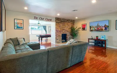 a living room with a couch and a fireplace at F-18 Babes in Toyland in Anaheim