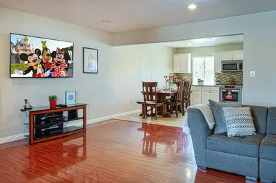 a living room with a blue couch and a table at F-18 Babes in Toyland in Anaheim