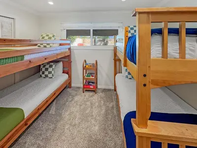 a bedroom with three bunk beds and a window at F-20 Paradise Pier in Anaheim