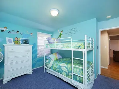 a childs bedroom with a bunk bed and blue walls at F-21 Castle House 1 in Anaheim