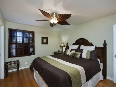 a bedroom with a bed with a ceiling fan at F-21 Castle House 1 in Anaheim